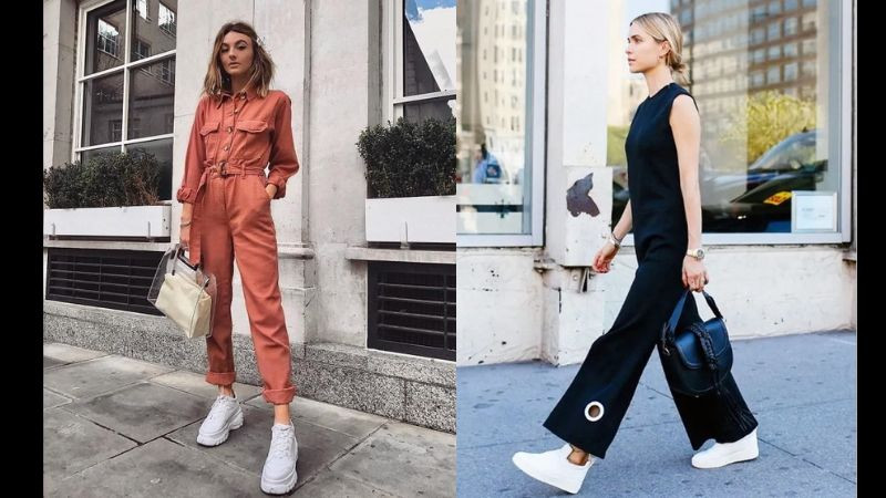 Cô gái cá tính diện jumpsuit màu xanh quân đội cùng giày thể thao trắng, tạo vẻ ngoài hiện đại.