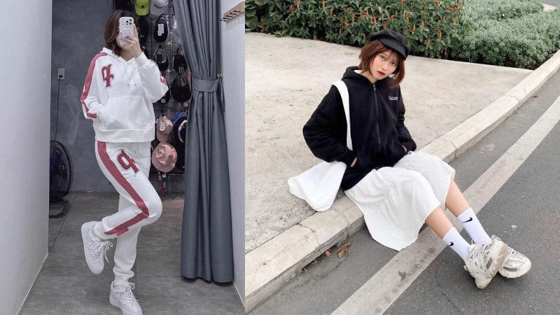 Cô gái mặc áo hoodie màu be, quần đen và giày thể thao trắng tạo phong cách đường phố
