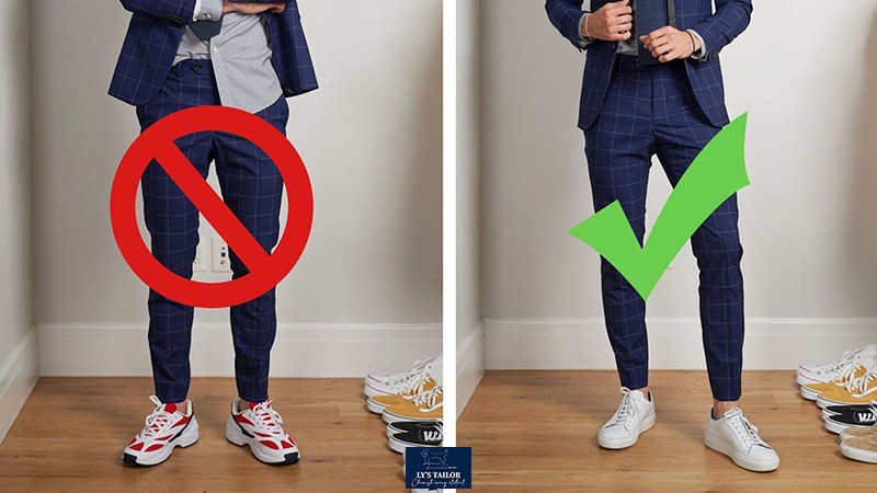 Người đàn ông mặc vest xanh, quần kẻ sọc và giày sneaker trắng, thể hiện phong cách lịch lãm nhưng hiện đại