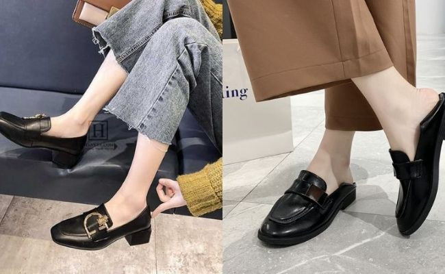 Người phụ nữ thời trang diện quần jean ống rộng màu xanh đậm phối giày loafer đen bóng và áo sơ mi kẻ sọc, tạo phong cách thanh lịch